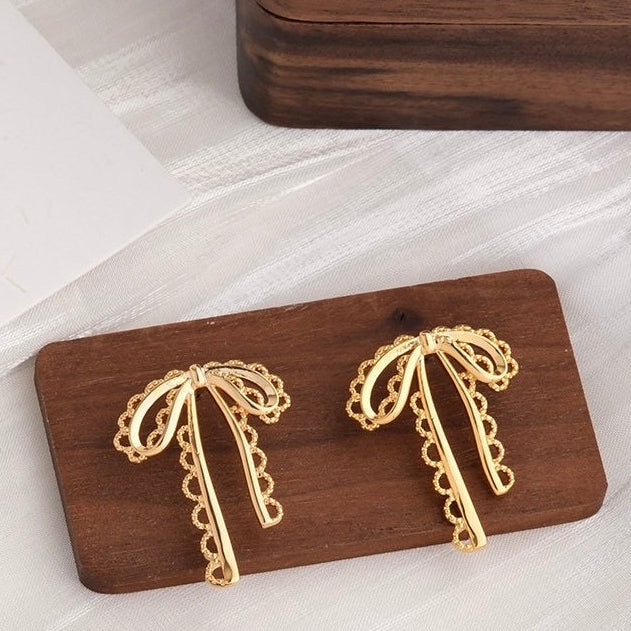 The Shringar Golden Ribbon Charm Earrings